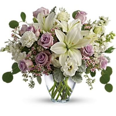 <div id="mark-2" class="m-pdp-tabs-marketing-description">Luxe in love! Pale lavender roses, creamy white lilies and delicate greens create a soft sweet bouquet that's as tender as your feelings.</div>
<div id="desc-2">
<ul>
 	<li>Lavender roses, white asiatic lilies, white lisianthus, white stock, lavender waxflower, and white sinuata statice are accented with dusty miller, seeded eucalyptus, and silver dollar eucalyptus.</li>
 	<li>Delivered in a serenity vase.</li>
</ul>
</div>